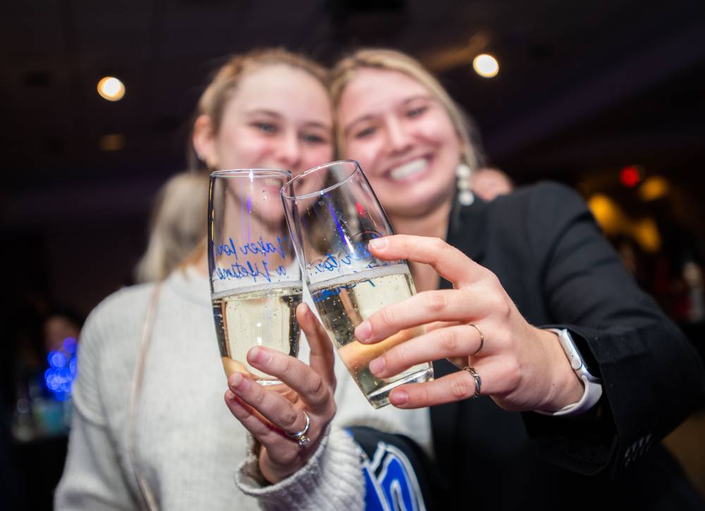 Two students with their champagne glasses.